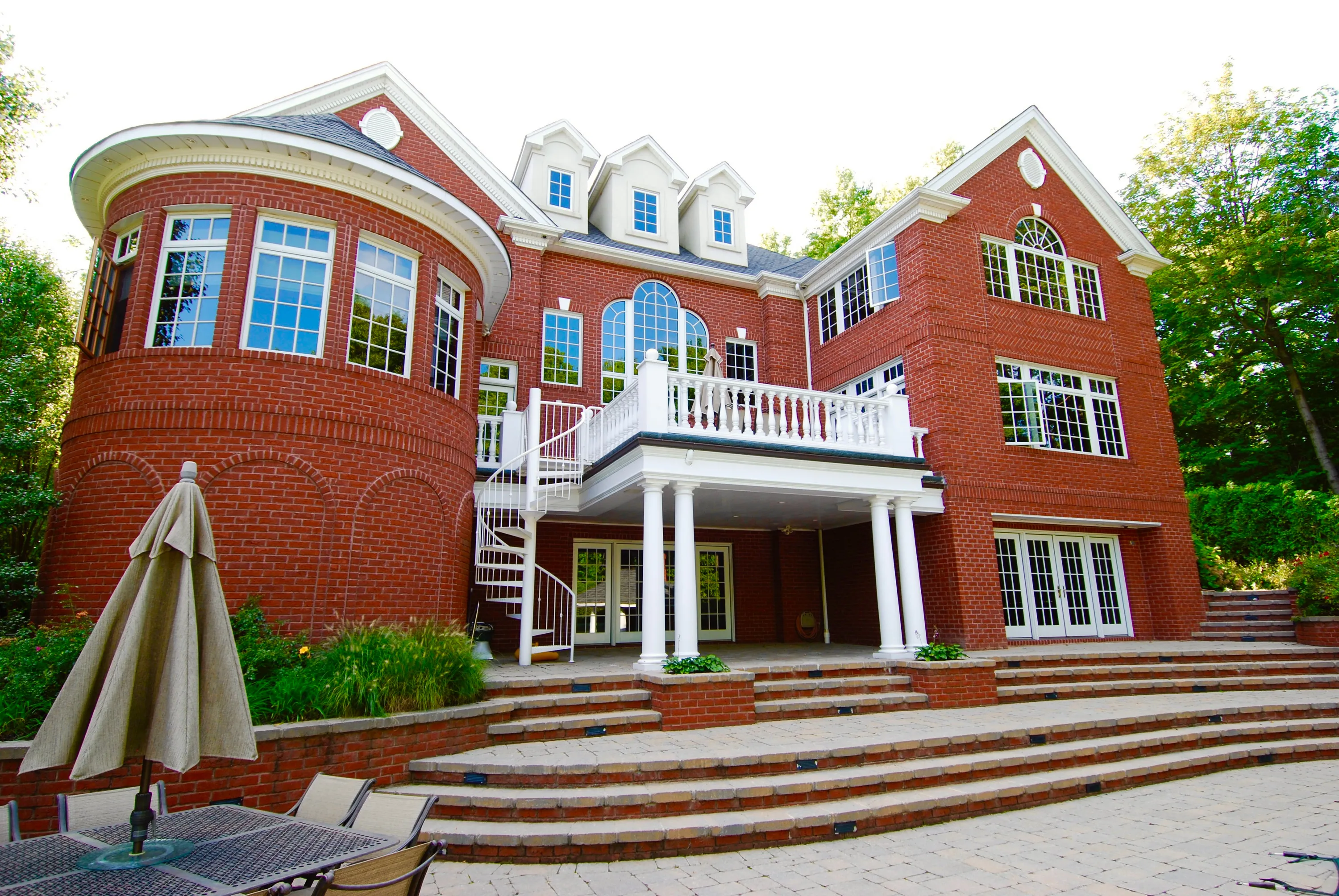 Brick rear elevation with broad masonry steps and a terrace in New York.