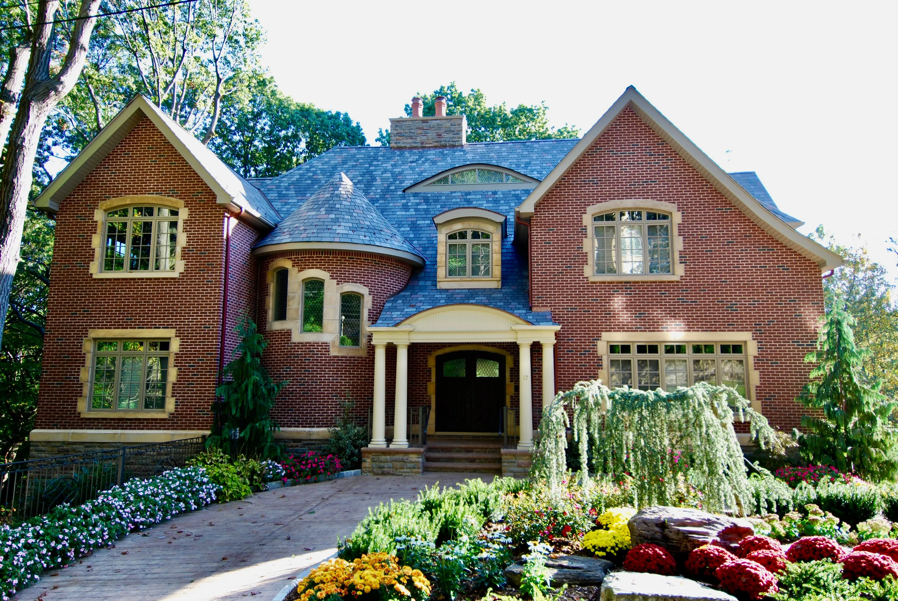 Brick residence framed by a formal garden in New York.