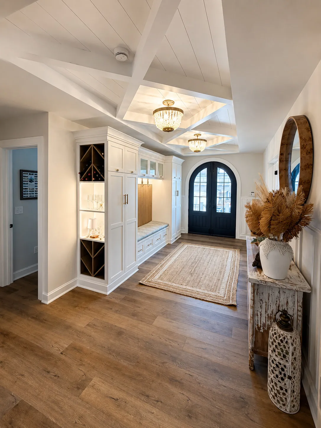 Bright coastal entry with wood flooring and paneled ceilings.