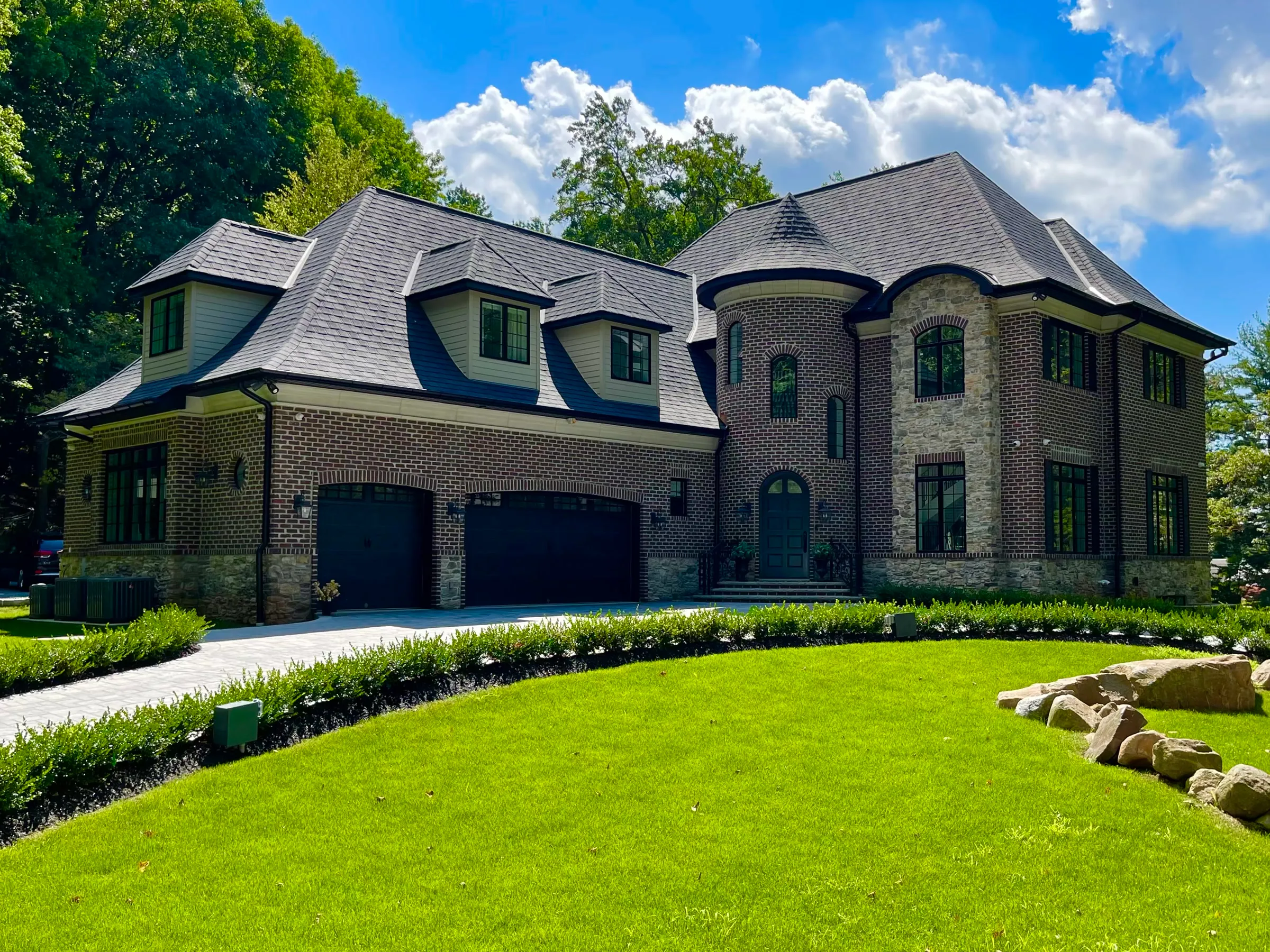 Completed stone residence with broad grounds and detailed masonry.