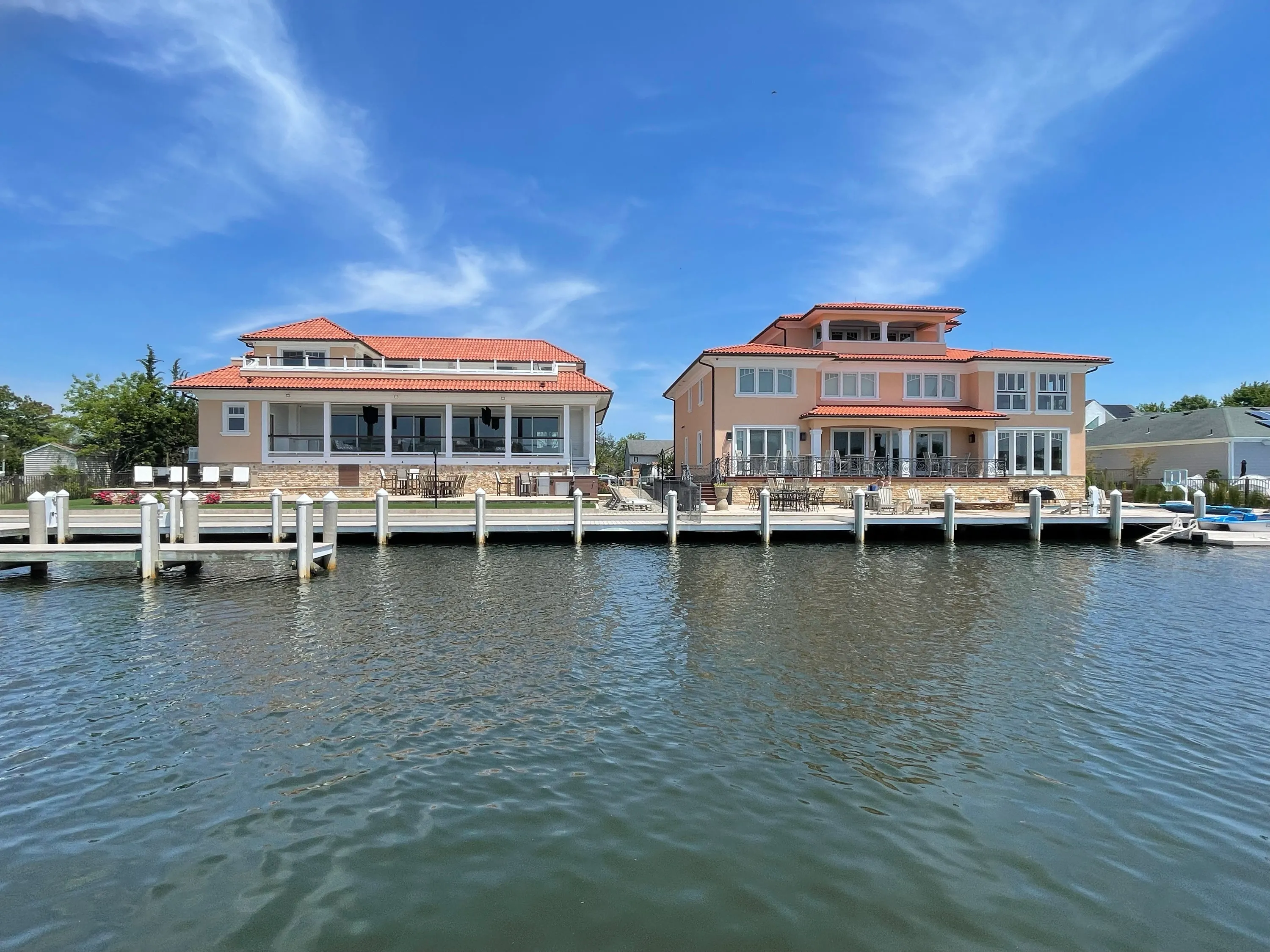 Wide waterfront view of the residence and neighboring shoreline.