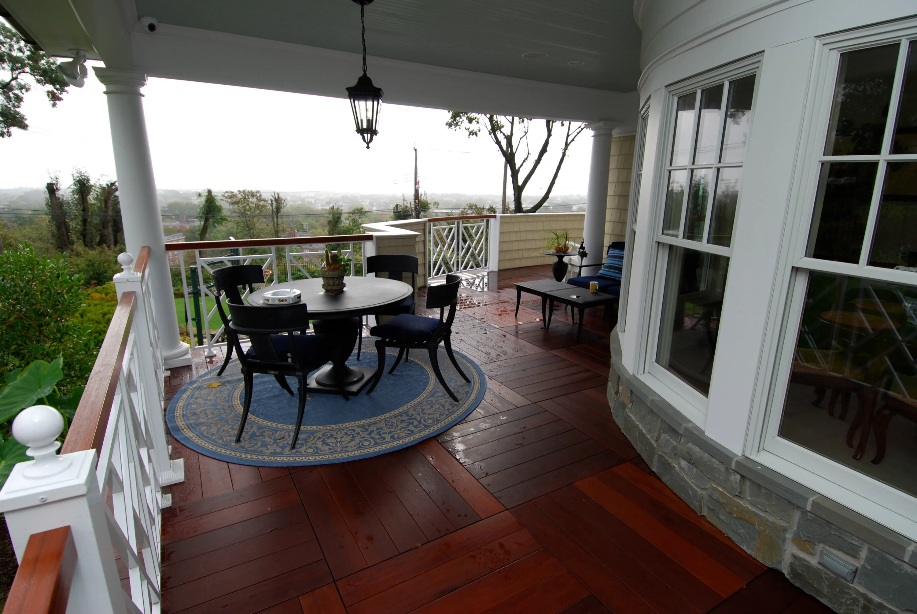 Covered porch with wood decking and open views across the grounds.
