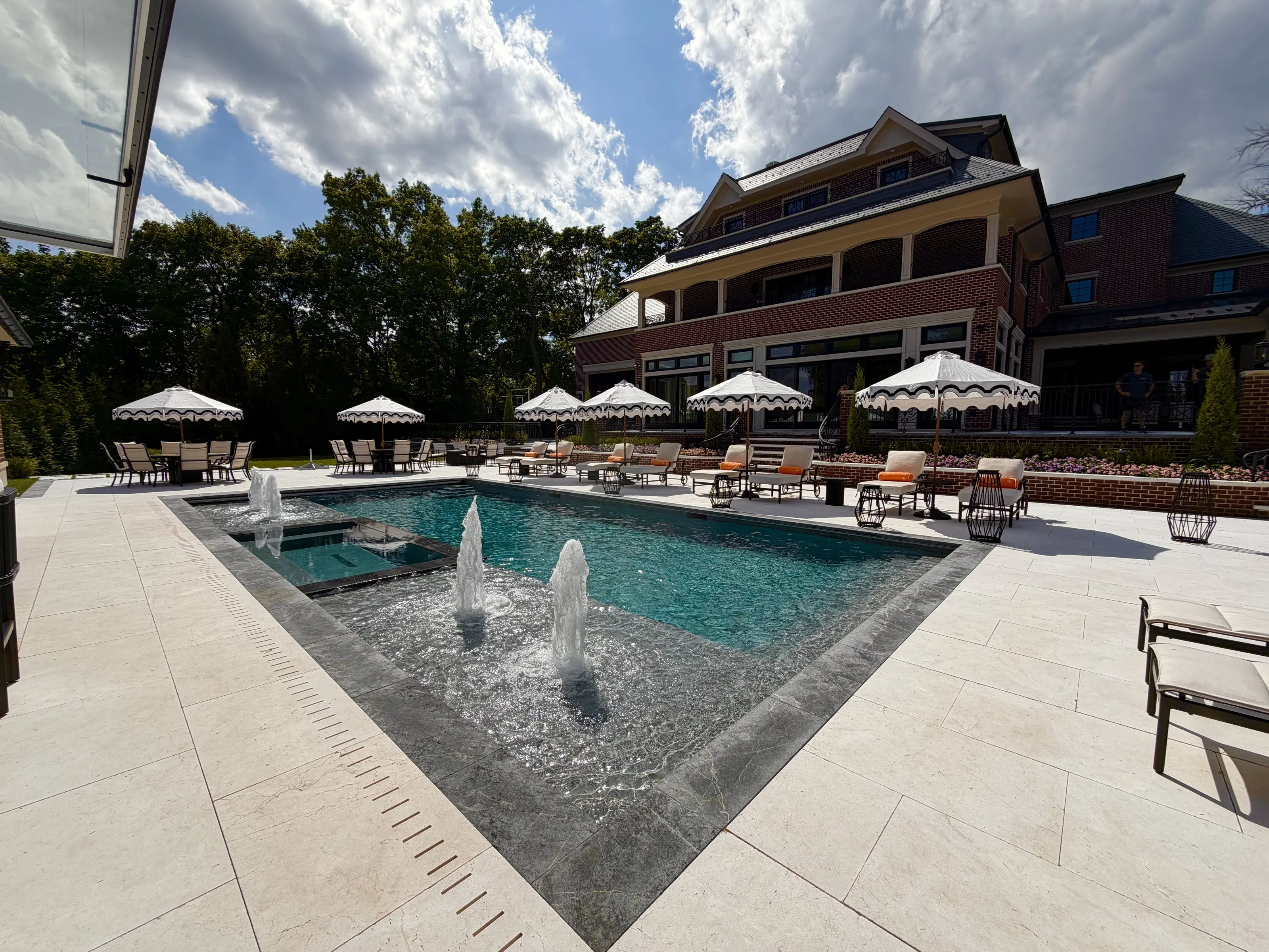Pool courtyard with water features and the residence beyond.