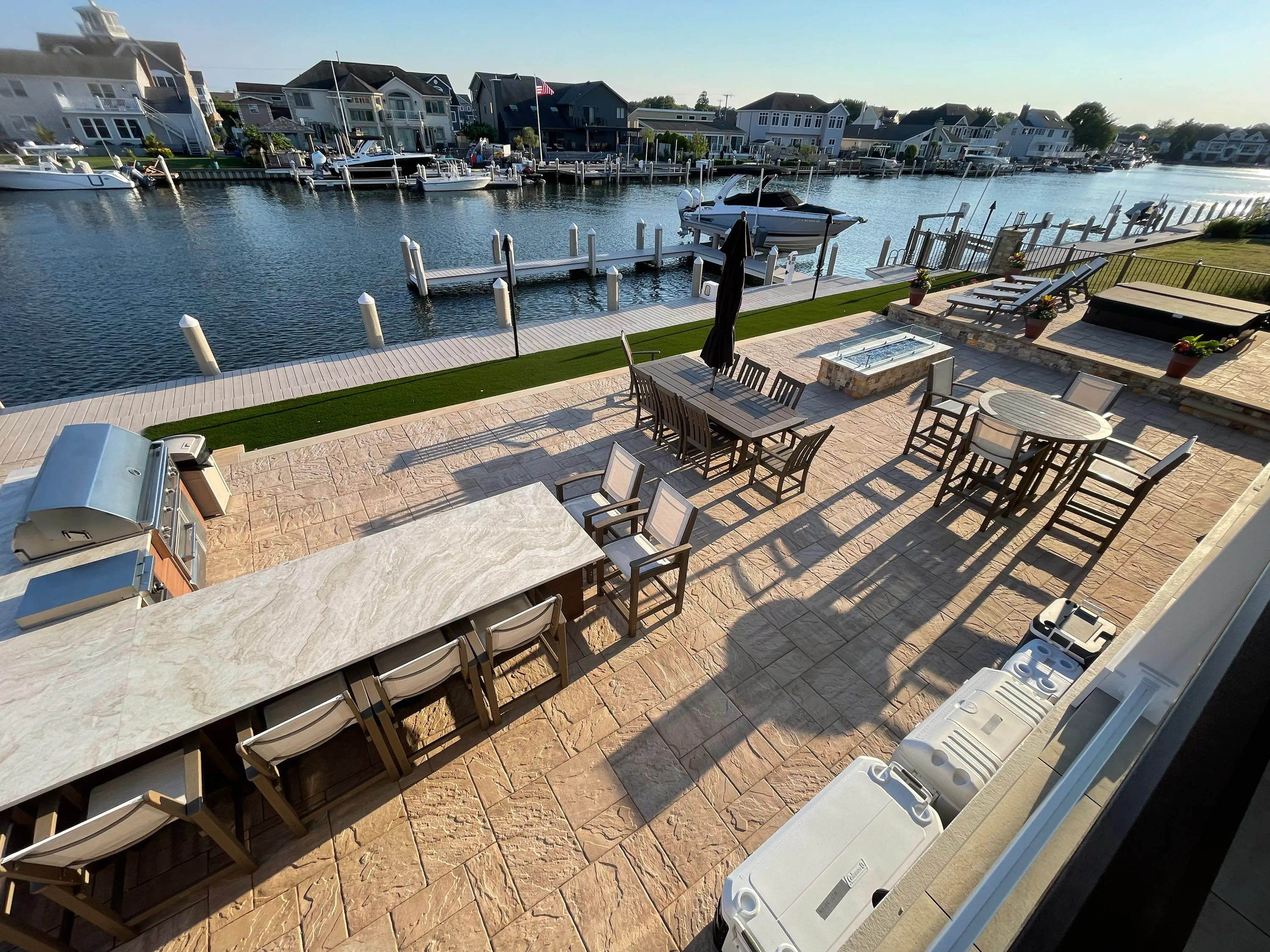 Waterfront deck with integrated seating, a fire feature, and dock access.