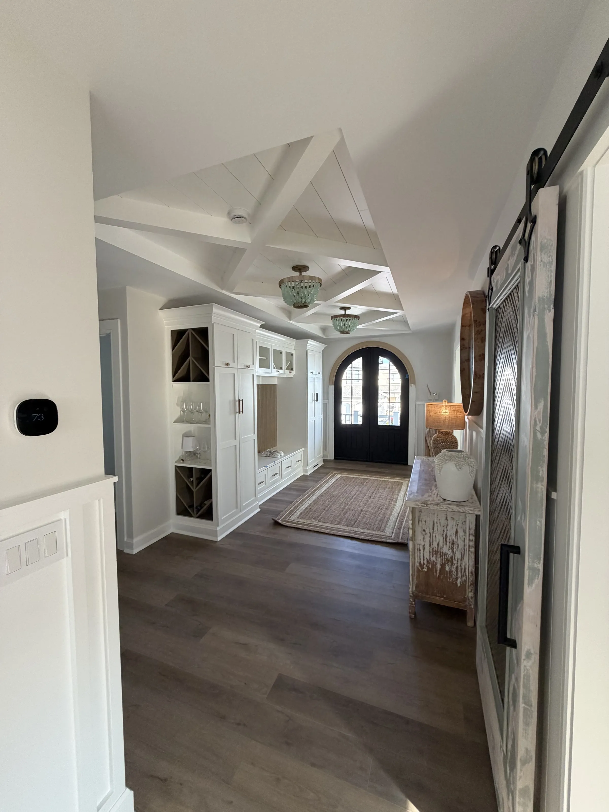 Secondary bedroom with built-in storage and paneled walls.