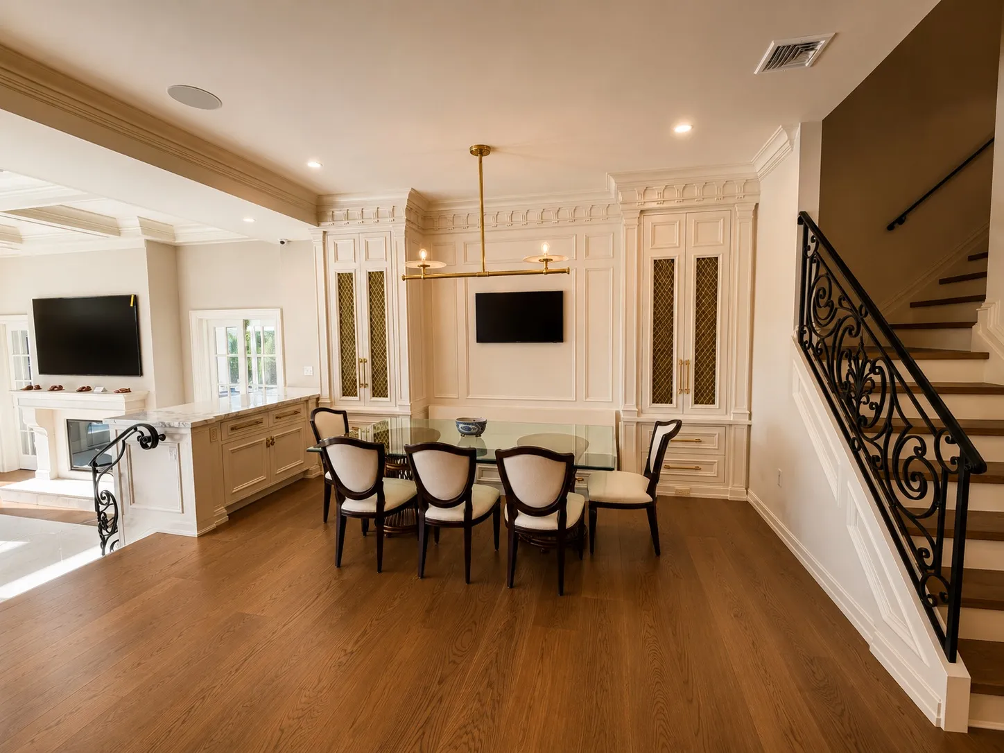 Kitchen dining area with paneled cabinetry and an adjacent stair.