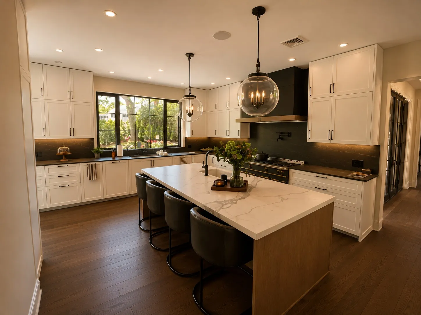 Kitchen with pale cabinetry, a broad island, and dark wood flooring.