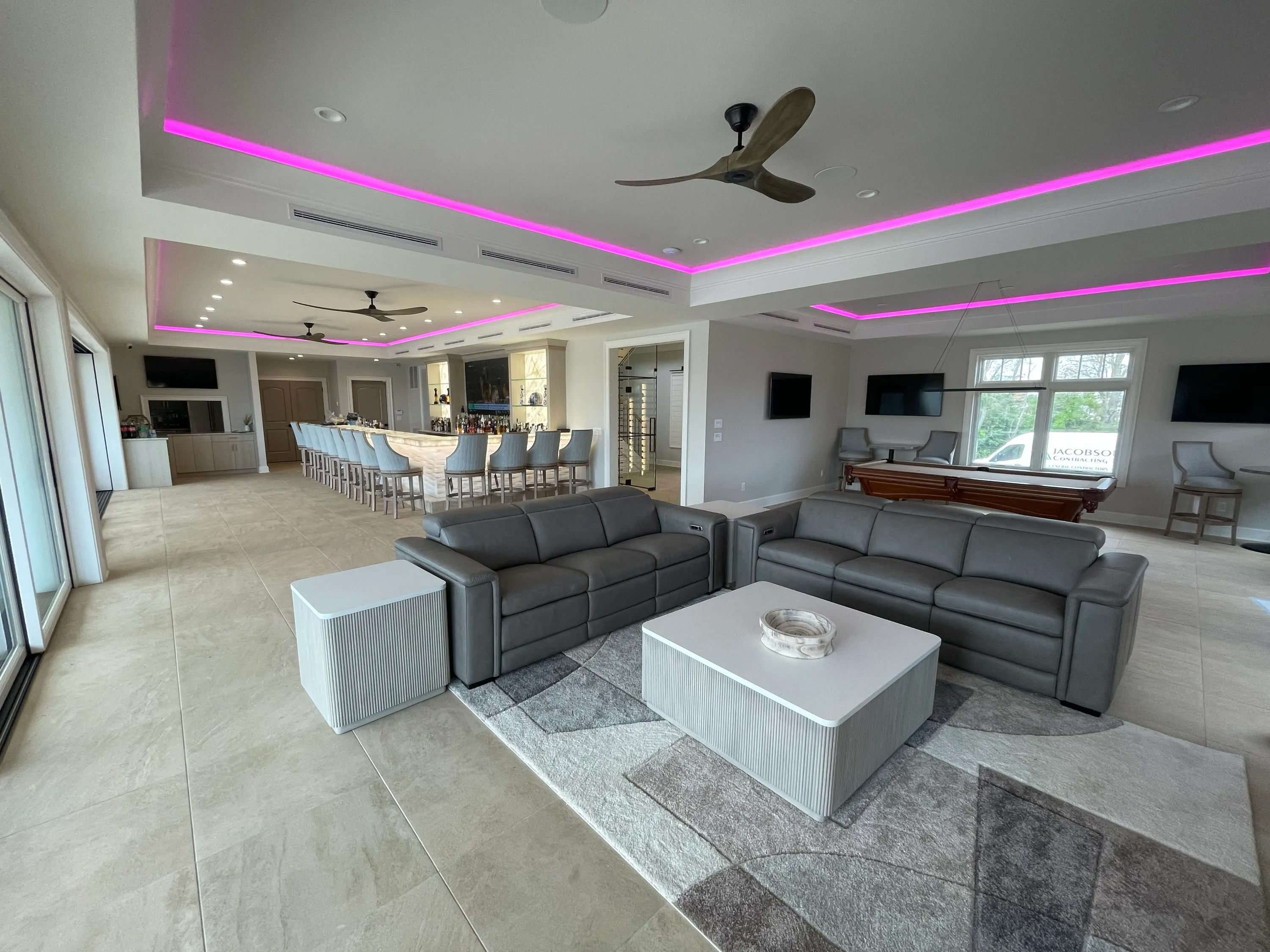Open living and entertaining space with waterfront access and integrated lighting.