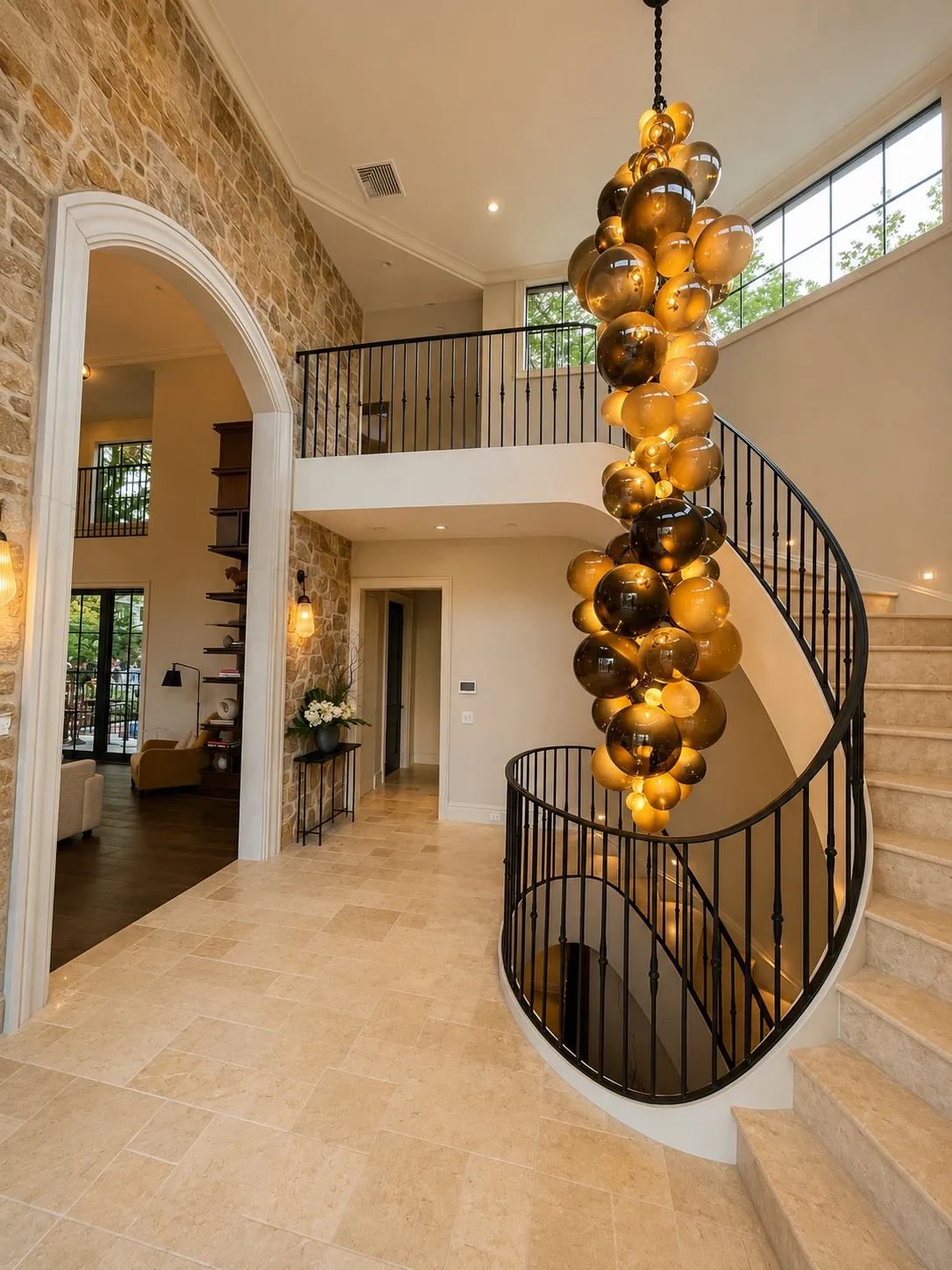 Curved stair rising through a bright double-height foyer.