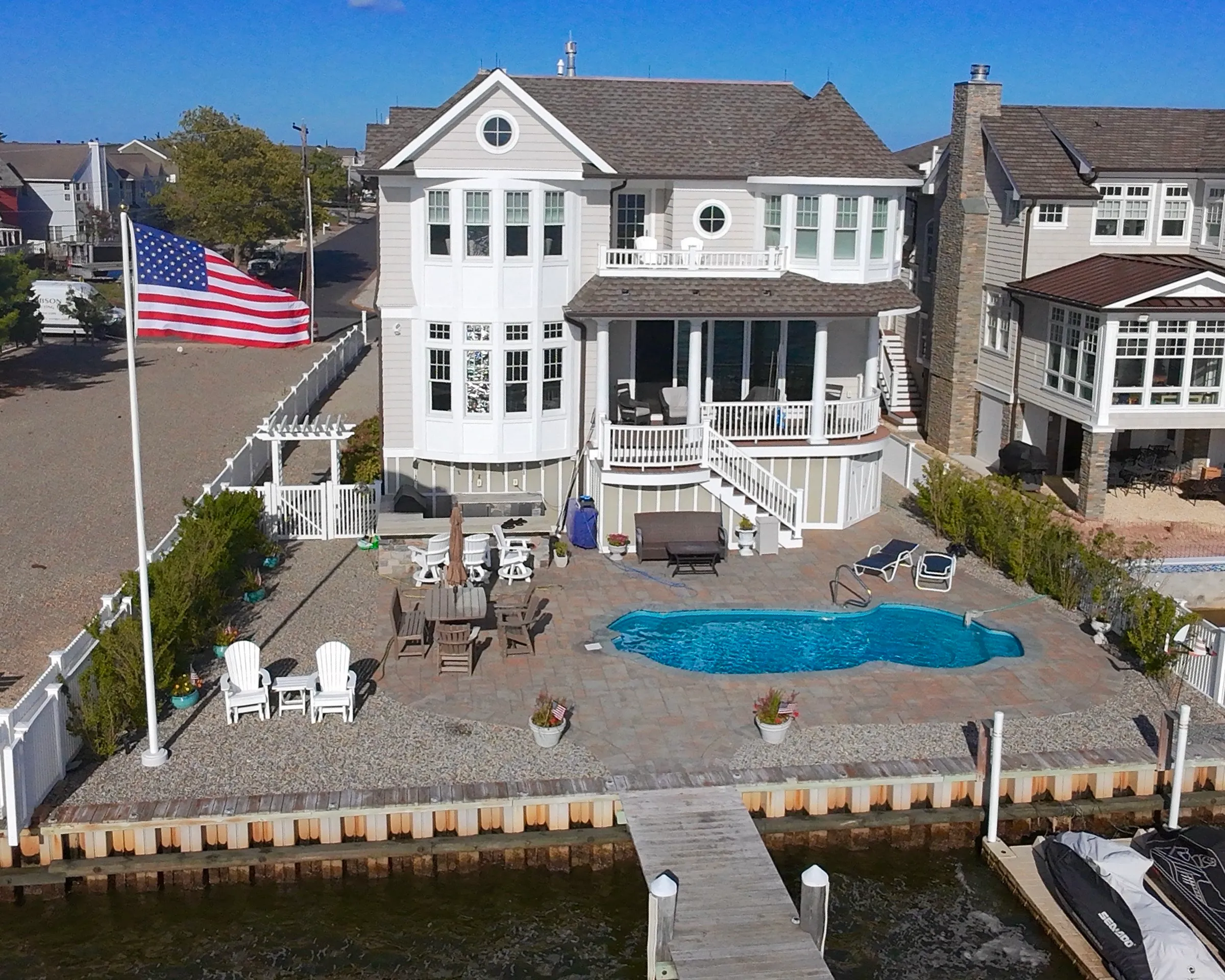 Aerial view of a completed waterfront residence and pool in New Jersey.
