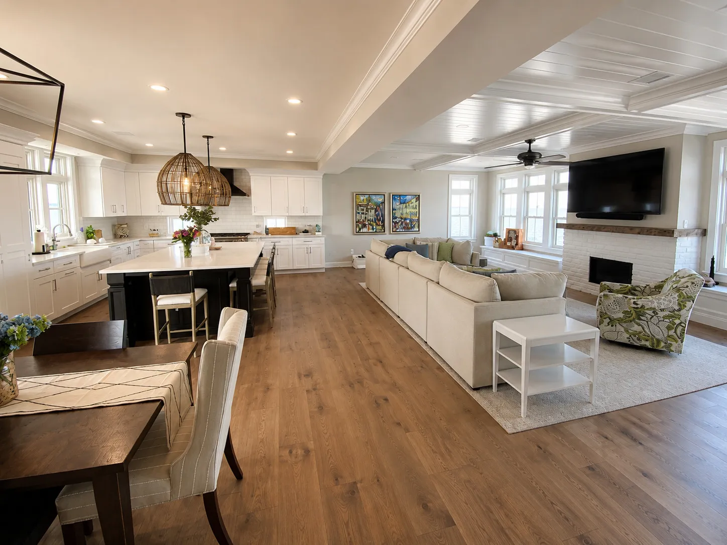 Open kitchen and living area finished in pale coastal materials.