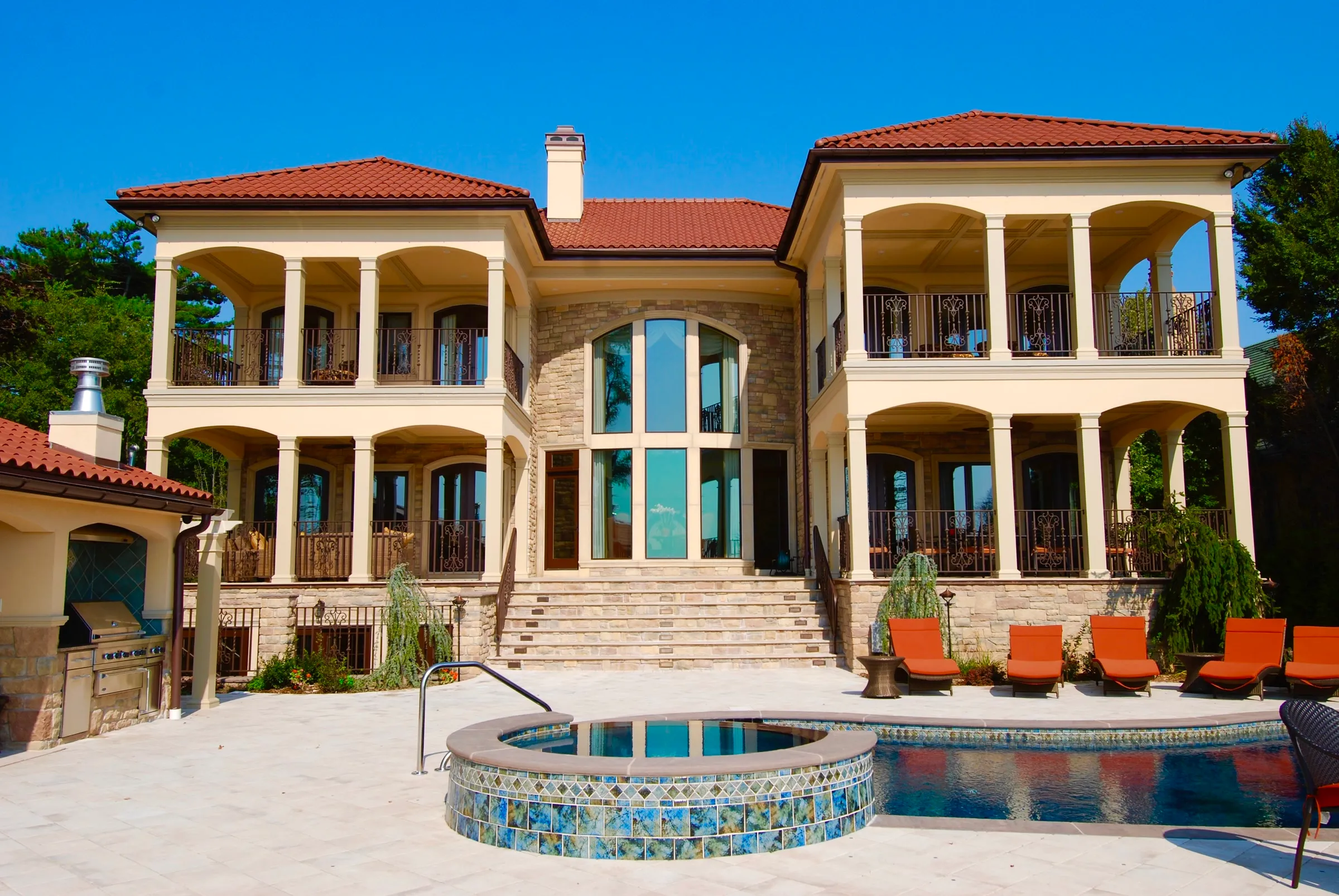 Completed rear residence elevation with two-story terraces and a pool.