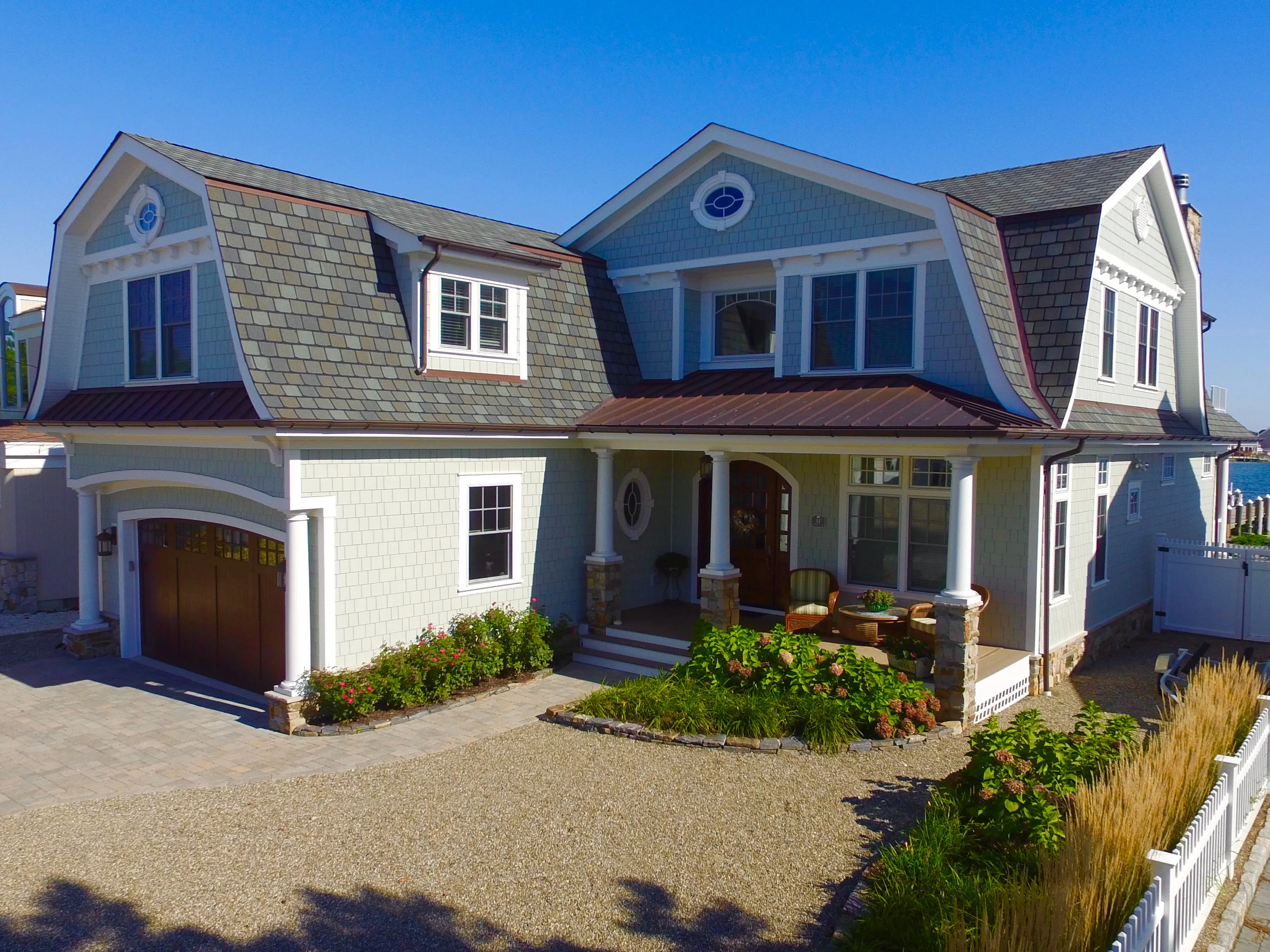 Shingle residence with a sheltered entry and landscaped drive in New Jersey.