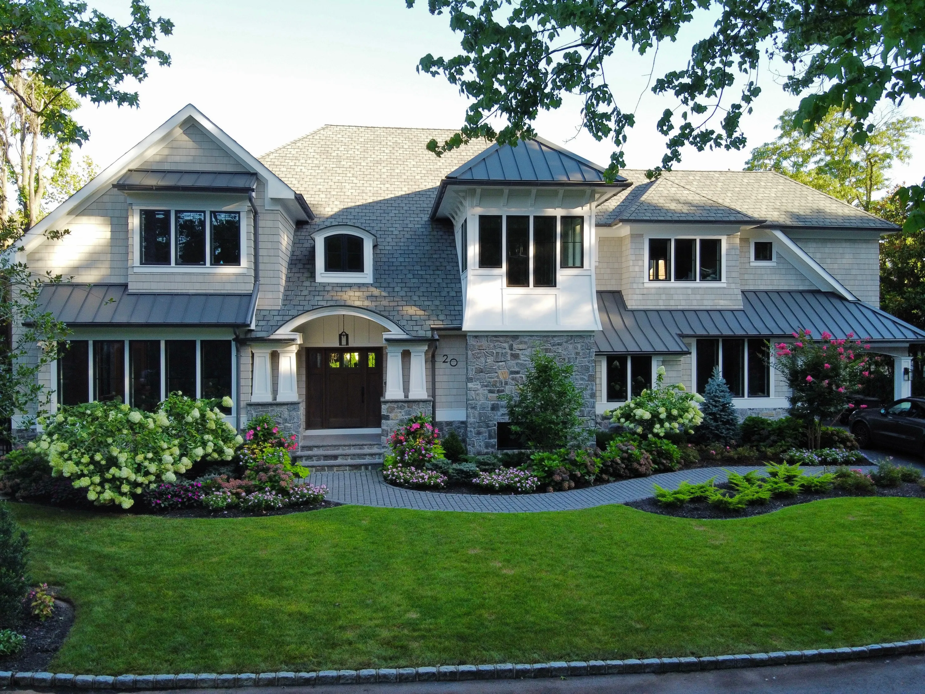 Stone residence with a formal front garden in New York.