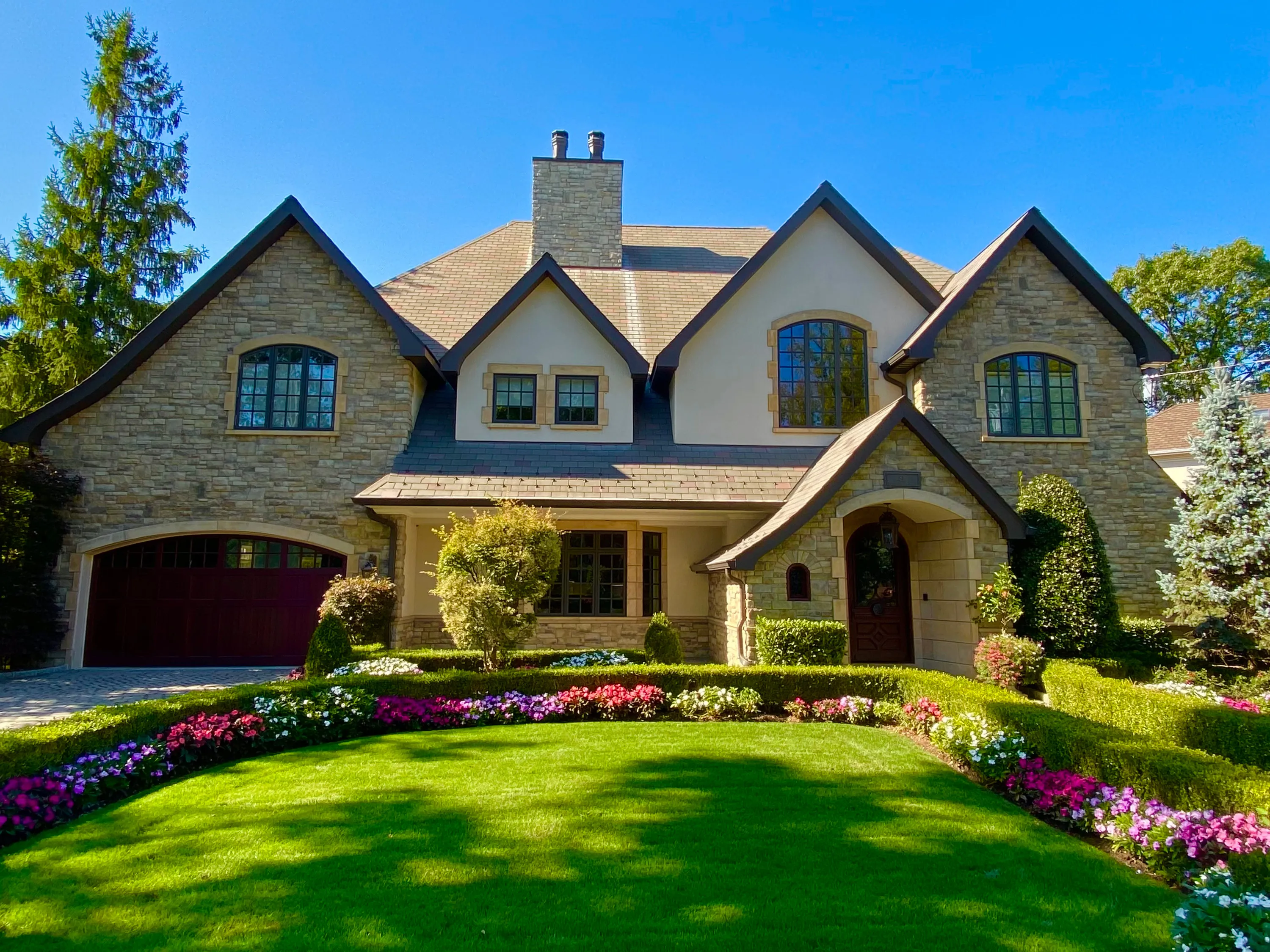 Stone residence with a deep landscaped lawn in New York.