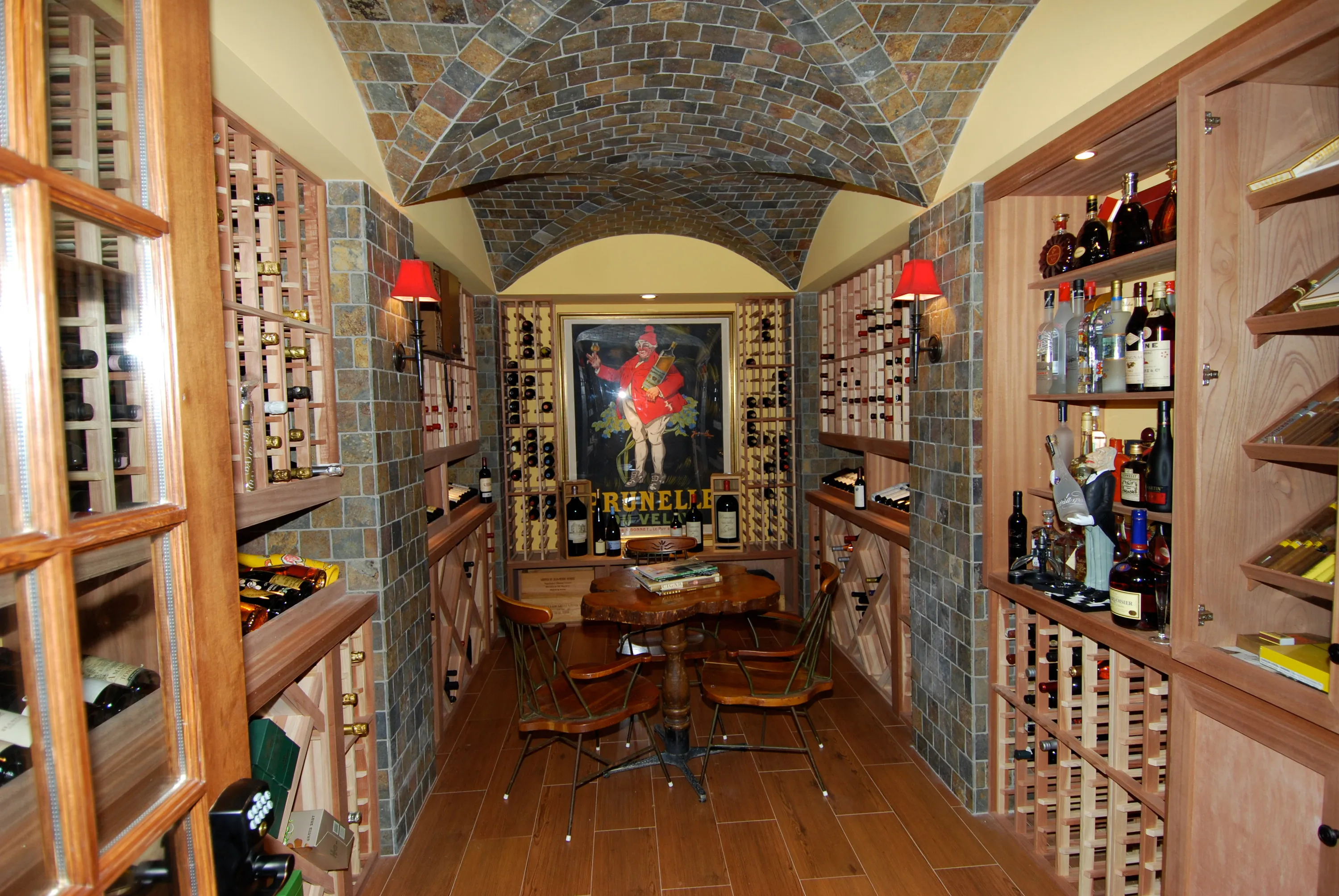 Wood wine room with a brick-vaulted ceiling and integrated storage.
